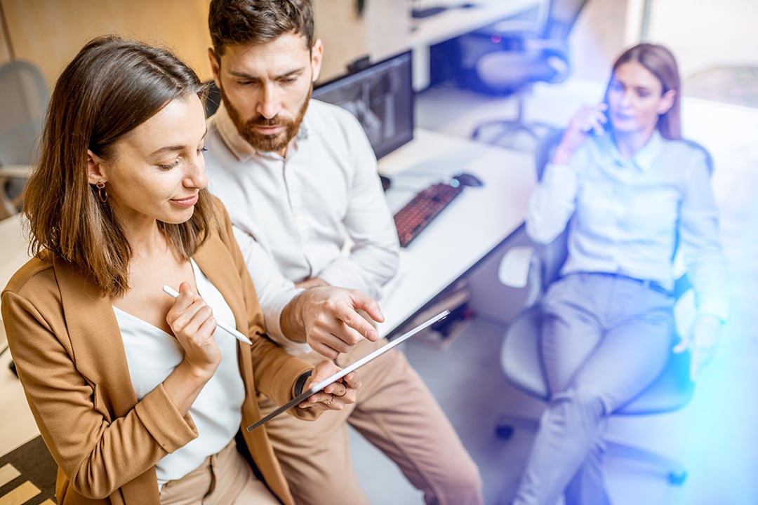 People in office checking tablet